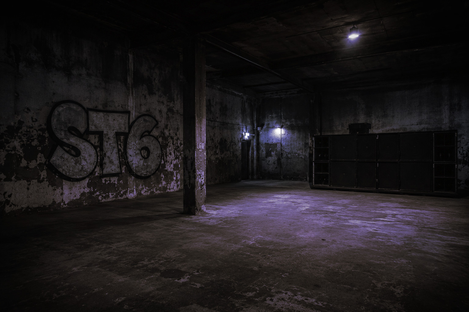 Empty warehouse with an ST6 graffiti on the wall